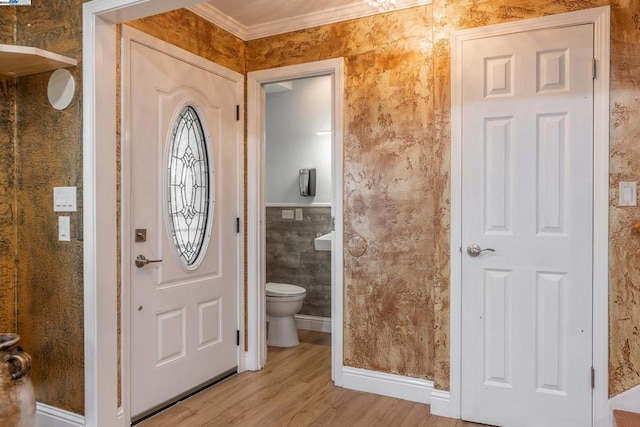 bathroom with hardwood / wood-style flooring, toilet, and ornamental molding