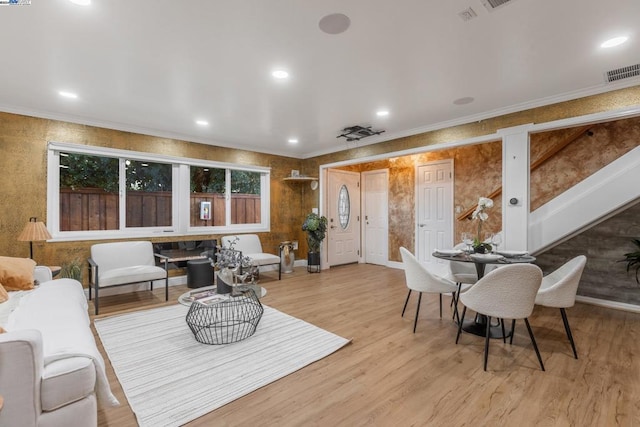 interior space with crown molding and light hardwood / wood-style floors