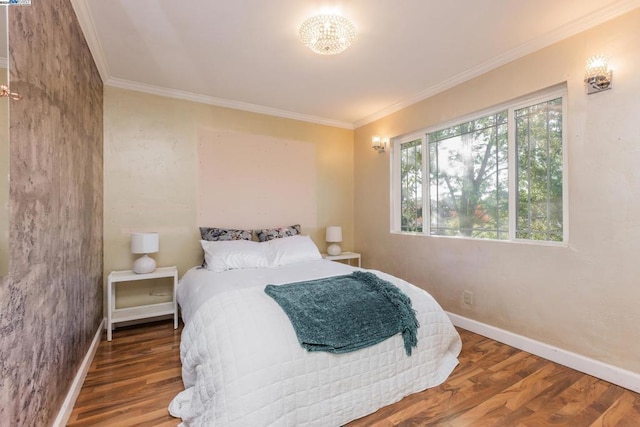 bedroom with hardwood / wood-style floors and crown molding