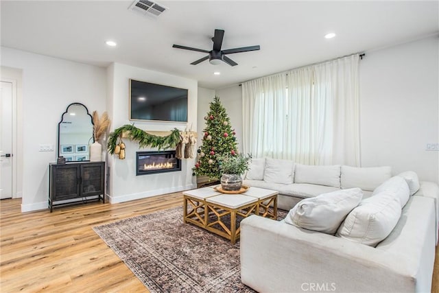 living room with hardwood / wood-style flooring and ceiling fan