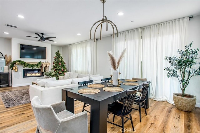 dining room with light hardwood / wood-style floors and ceiling fan