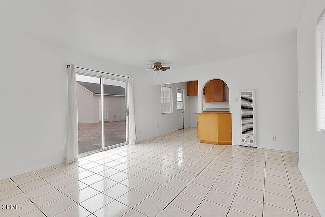 unfurnished living room with ceiling fan and light tile patterned floors