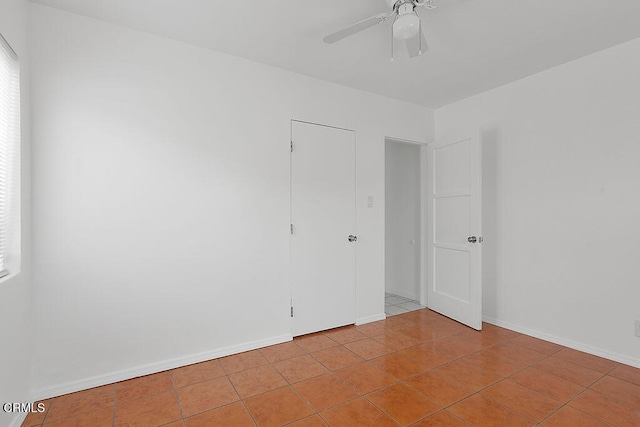 tiled empty room with ceiling fan