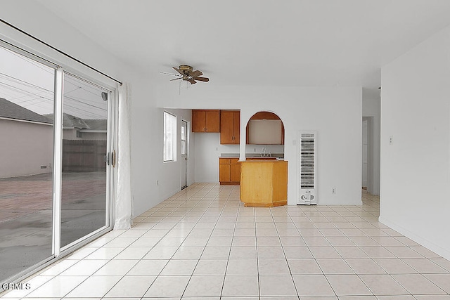 kitchen featuring sink, ceiling fan, and light tile patterned flooring