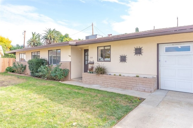 single story home featuring a front yard and a garage