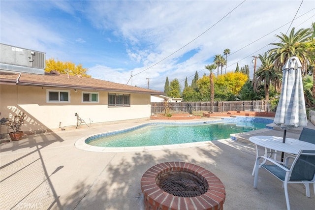 view of swimming pool featuring an outdoor fire pit and a patio