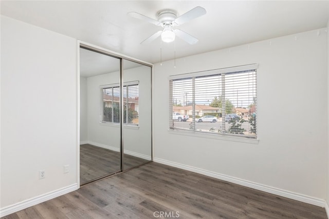 unfurnished bedroom featuring ceiling fan, hardwood / wood-style floors, and a closet