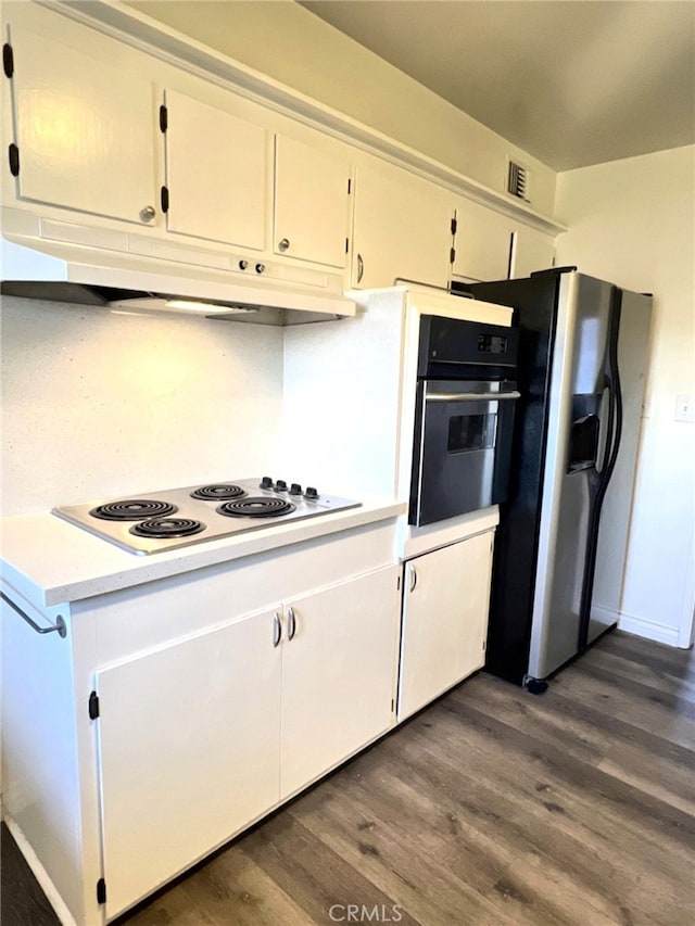 kitchen featuring stainless steel refrigerator with ice dispenser, dark wood-type flooring, white cabinetry, and white electric stovetop