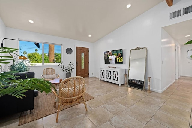 living area with high vaulted ceiling