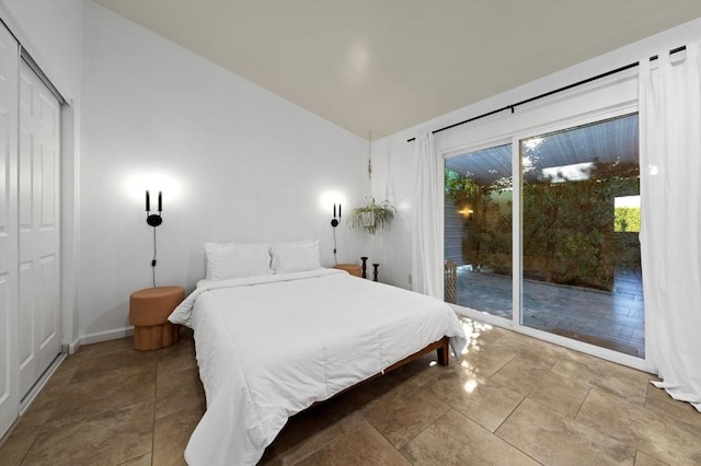 bedroom with access to outside, a closet, and vaulted ceiling