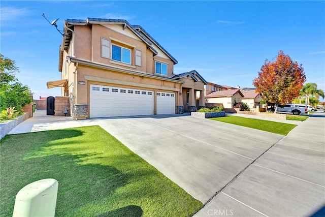 view of front of home featuring a garage and a front yard