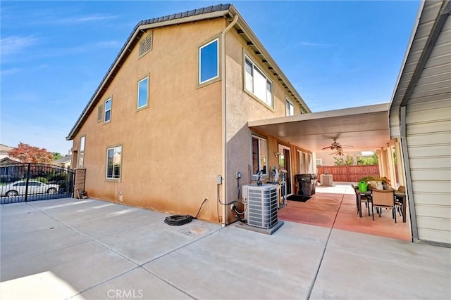 exterior space featuring ceiling fan, cooling unit, and a patio