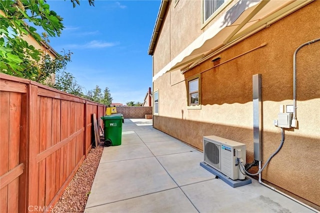 view of property exterior with ac unit and a patio