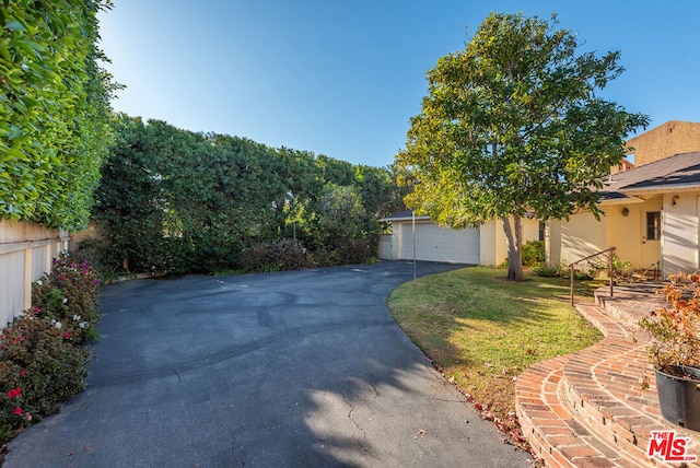 view of front of home with a garage and a front lawn