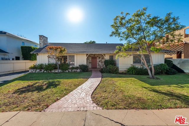 ranch-style home featuring a front yard