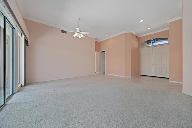 carpeted spare room with a wealth of natural light, crown molding, and ceiling fan