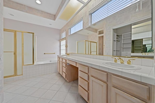 bathroom featuring tile patterned floors, vanity, and shower with separate bathtub