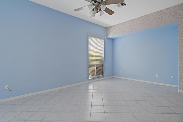 tiled spare room with ceiling fan