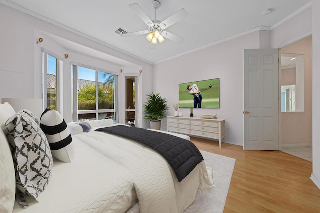 bedroom featuring ceiling fan, ornamental molding, and light wood-type flooring