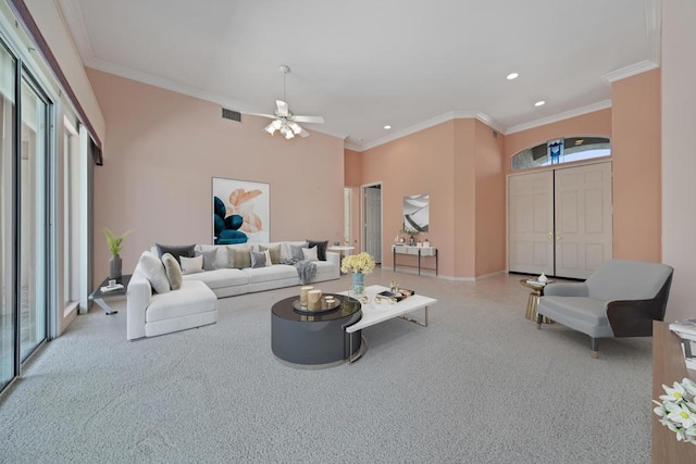 living room featuring light colored carpet, ornamental molding, and a wealth of natural light