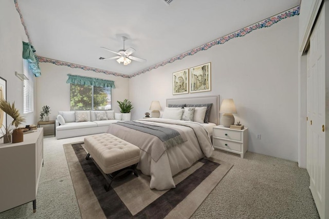 carpeted bedroom with a closet and ceiling fan