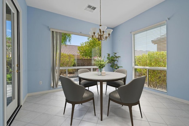 dining room with an inviting chandelier and light tile patterned flooring