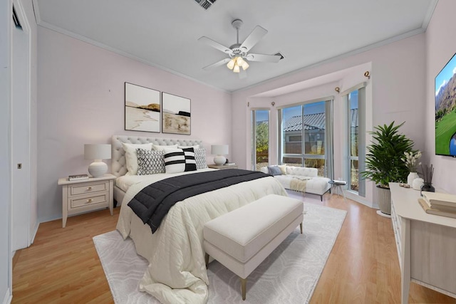 bedroom with light wood-type flooring, ceiling fan, and ornamental molding