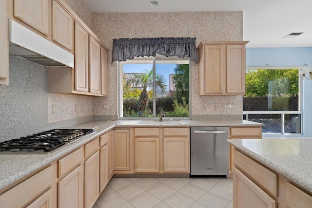 kitchen with backsplash, light brown cabinets, sink, and stainless steel appliances