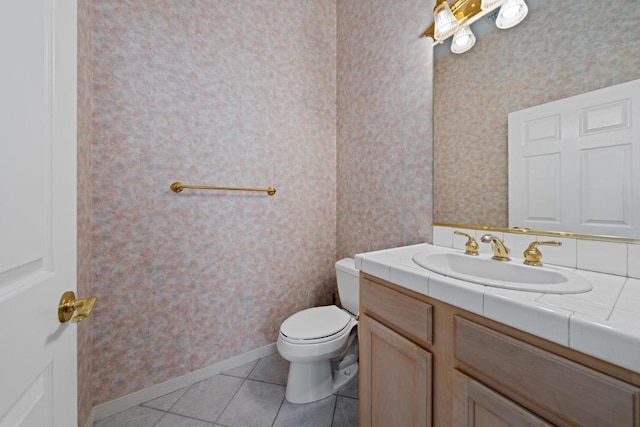 bathroom featuring toilet, vanity, and tile patterned floors