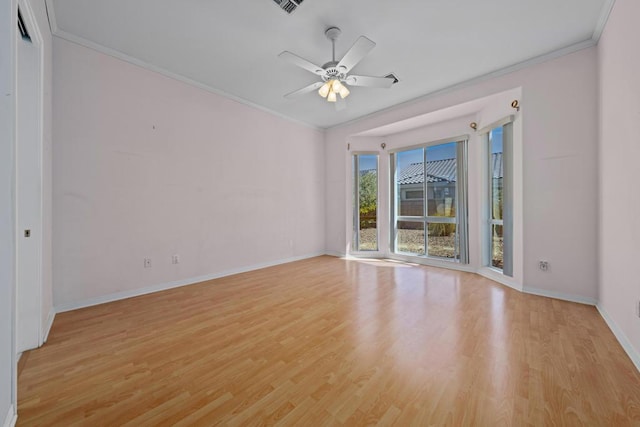 empty room with light hardwood / wood-style flooring, ceiling fan, and ornamental molding