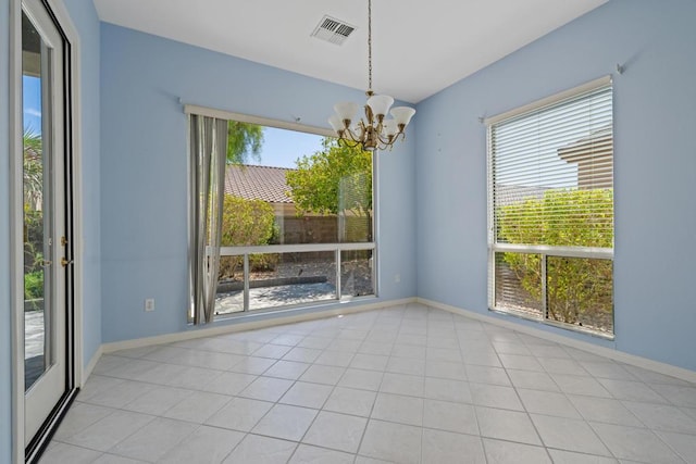 unfurnished dining area featuring a chandelier and light tile patterned floors