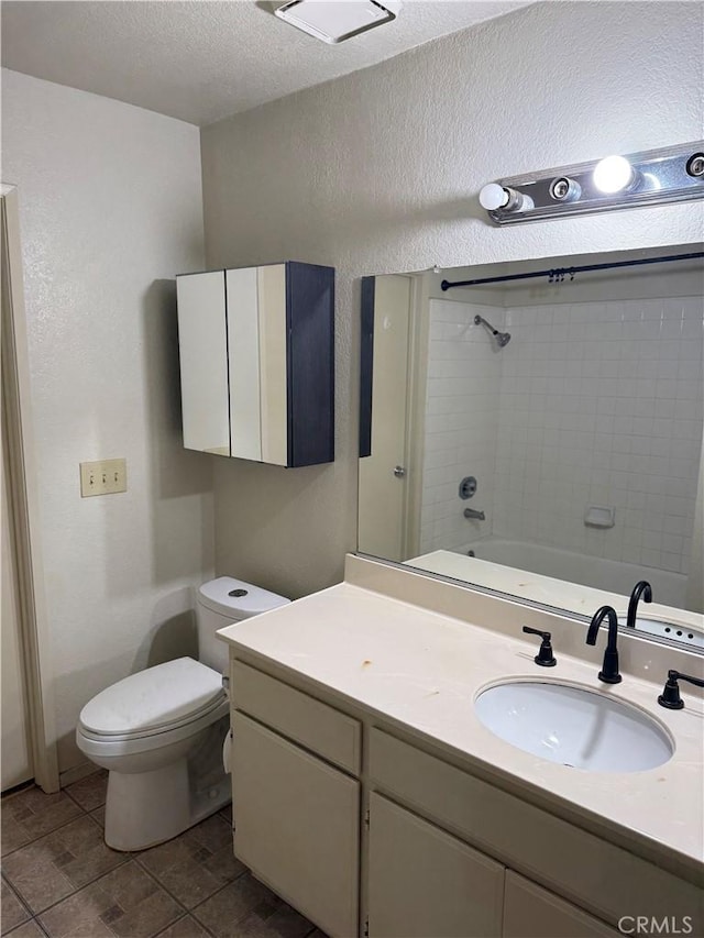 full bathroom with vanity, a textured ceiling, toilet, and washtub / shower combination