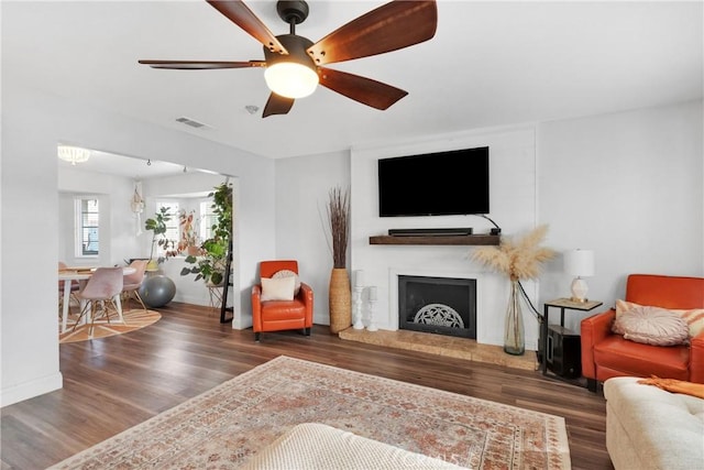 living room with dark hardwood / wood-style floors and ceiling fan