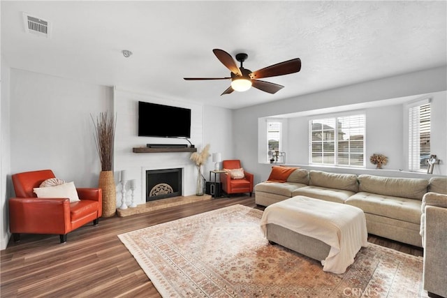 living room featuring dark hardwood / wood-style floors and ceiling fan