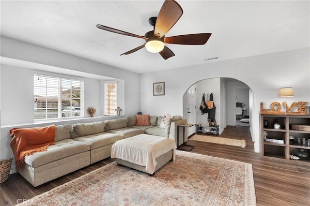 living room with ceiling fan and dark hardwood / wood-style flooring