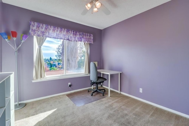 unfurnished office featuring ceiling fan and light carpet