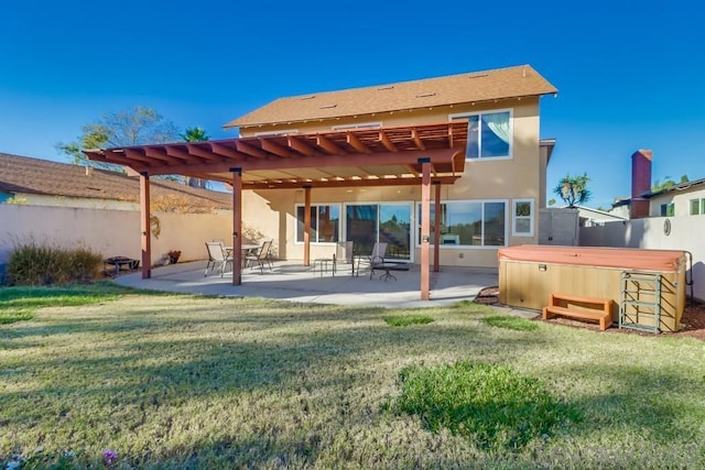 rear view of house featuring a pergola, a yard, a patio, and a hot tub