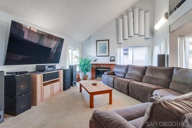 carpeted living room with a fireplace and high vaulted ceiling