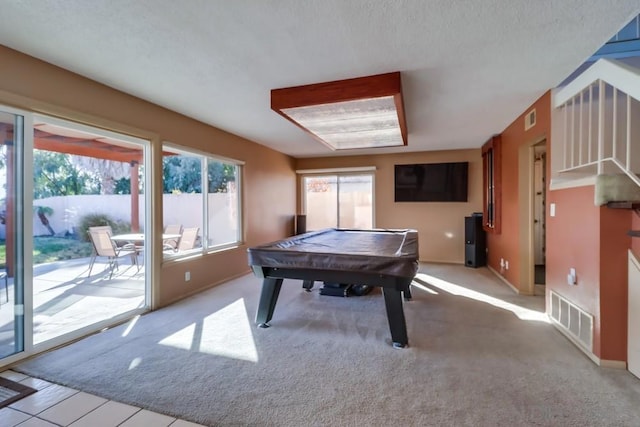 playroom with a textured ceiling, light carpet, and billiards