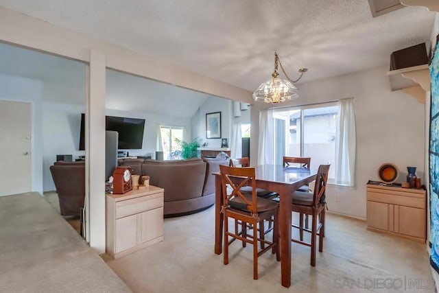 dining area with a textured ceiling, light colored carpet, lofted ceiling, and a notable chandelier