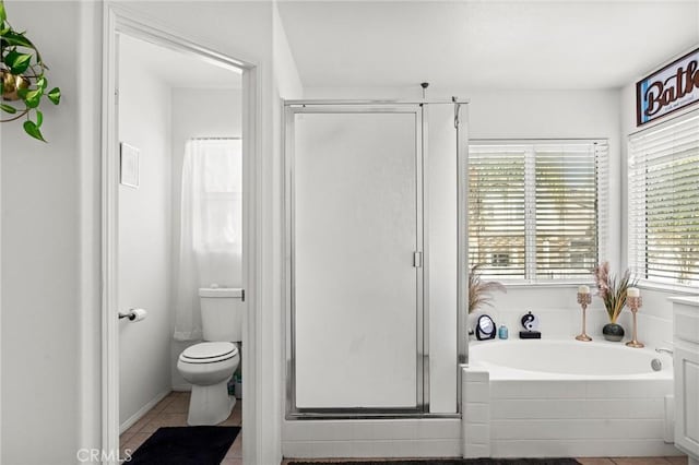 bathroom featuring separate shower and tub, tile patterned floors, plenty of natural light, and toilet