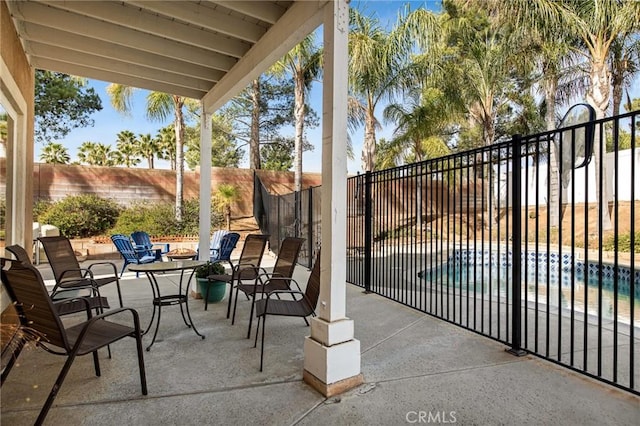 view of patio / terrace with a fenced in pool