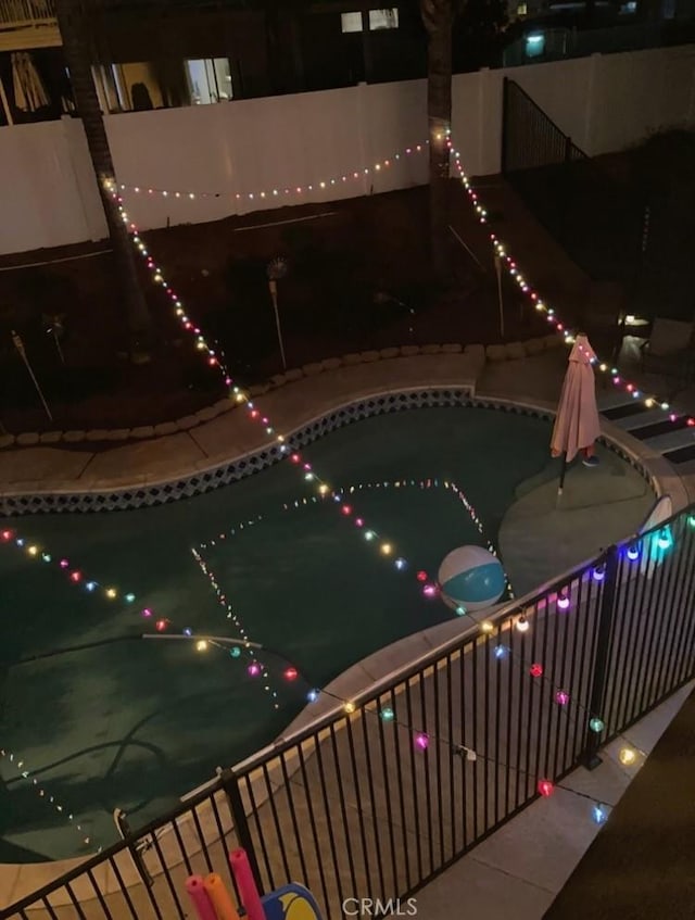 view of pool at night