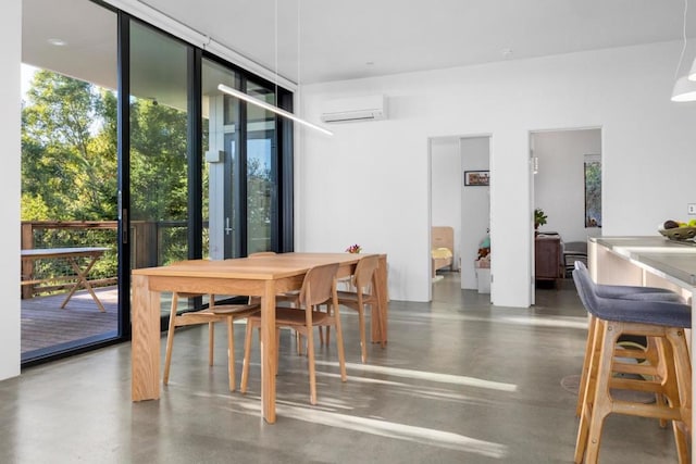 dining room featuring plenty of natural light and a wall mounted air conditioner