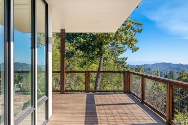 exterior space with a deck with mountain view