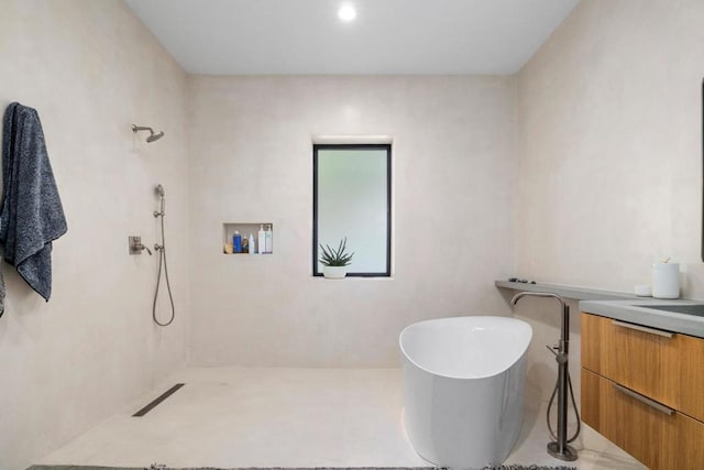 bathroom with vanity and a tub