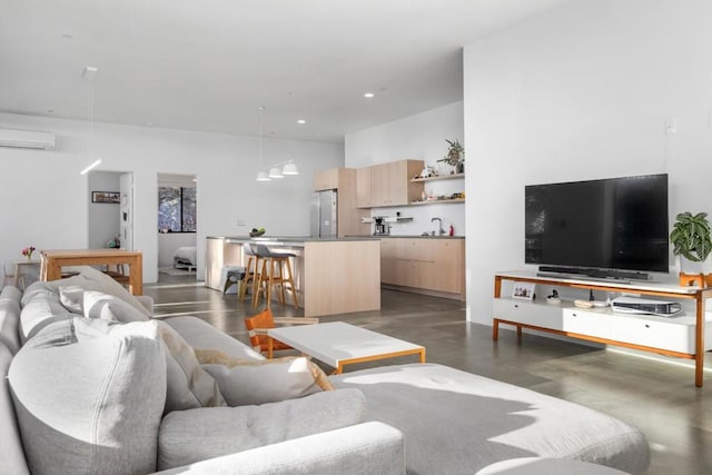 living room featuring sink and a wall unit AC