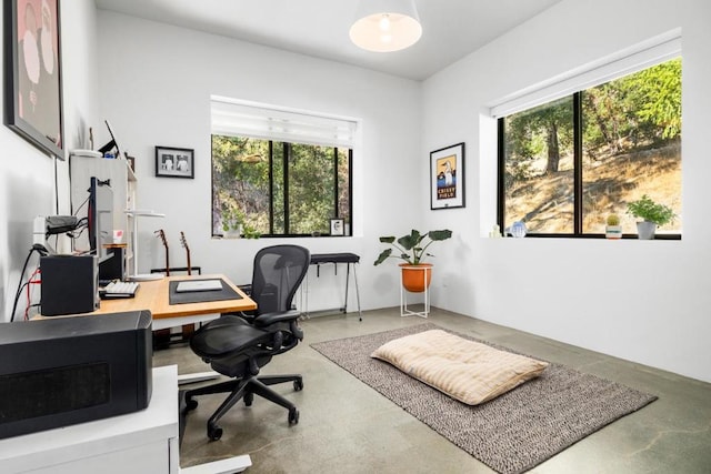 home office featuring concrete flooring