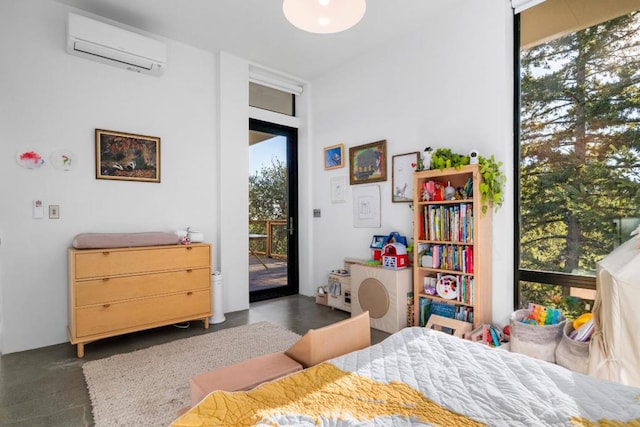 bedroom featuring a wall mounted AC and access to outside