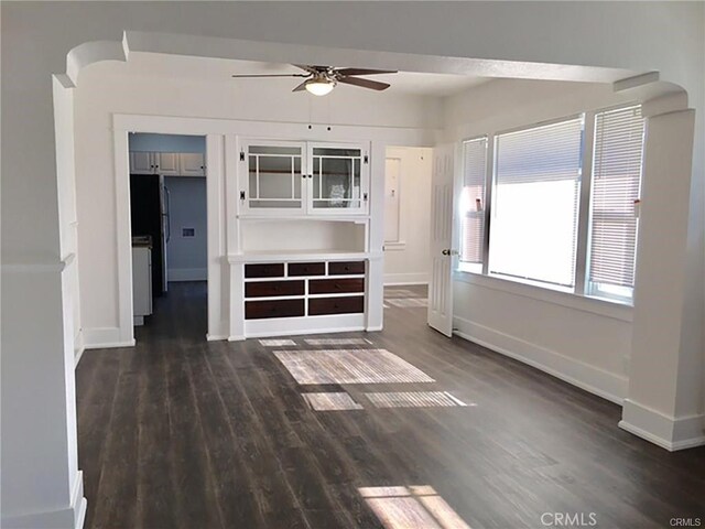 unfurnished room featuring dark hardwood / wood-style floors and ceiling fan